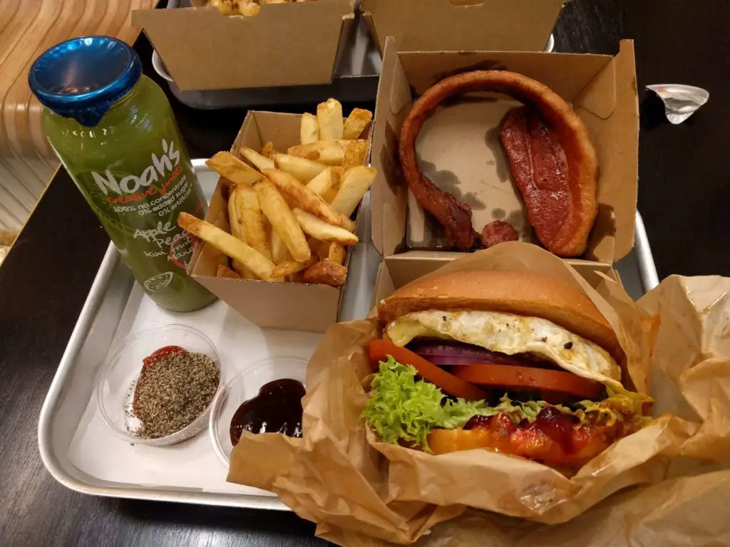 Meal at Sydney Airport's Benny Burger with a burger, fries, and juice