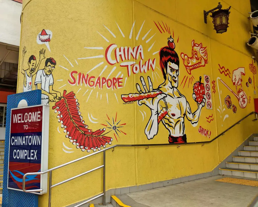 Chinatown Complex Sign with a drawing of Bruce Lee on the wall.