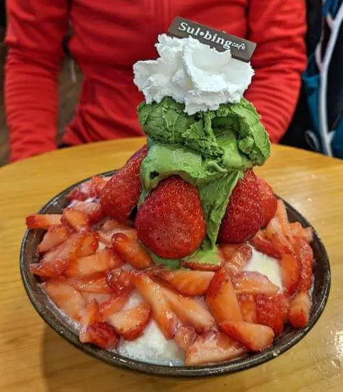 Snow ice dessert with fresh strawberries and green tea ice cream at Sulbing Cafe in Myeongdong, Seoul, South Korea 