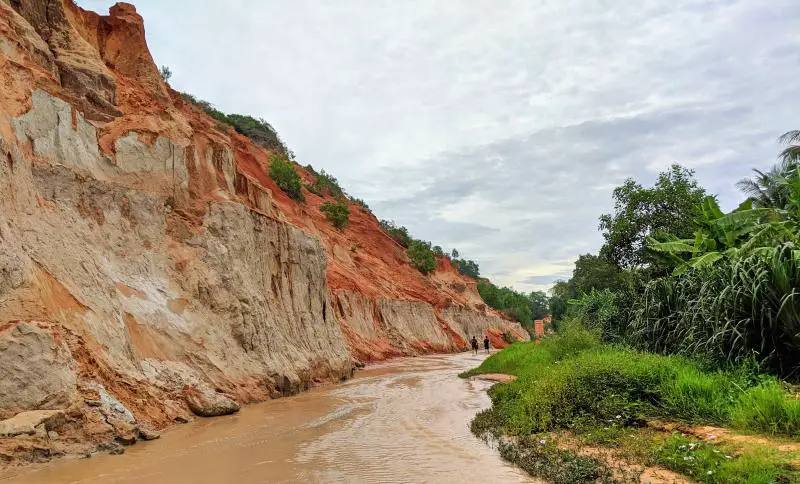 Mui Ne, Vietnam Things to Do: Fairy Stream Walk with the clay colored cliffs and orange-brown Waters