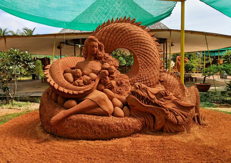 Mui Ne, Vietnam Things to Do: One of the Forgotten Land Sand Sculpture Park's sand sculpture is of a woman holding babies and surrounded by a dragon