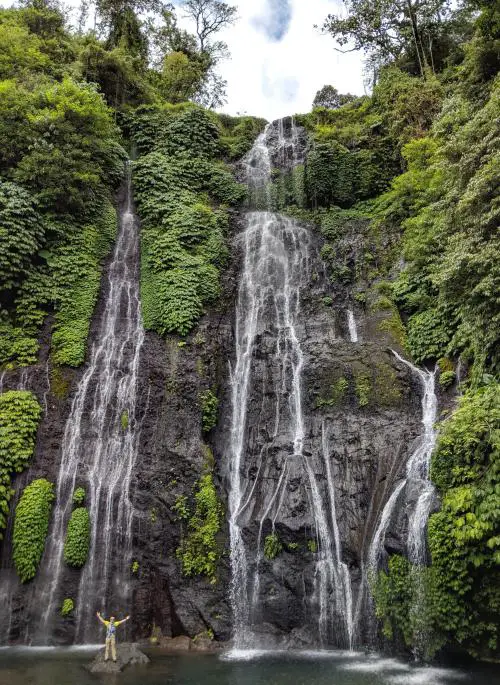 Justin Huynh, Life Of Doing, stands in front of the Banyumala Waterfall in Bali, Indonesia