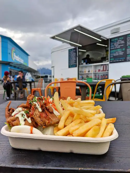 Outdoor seating at Habit Foods, Te Anau, New Zealand. Enjoying our soft shell crab bao in front of the food truck.
