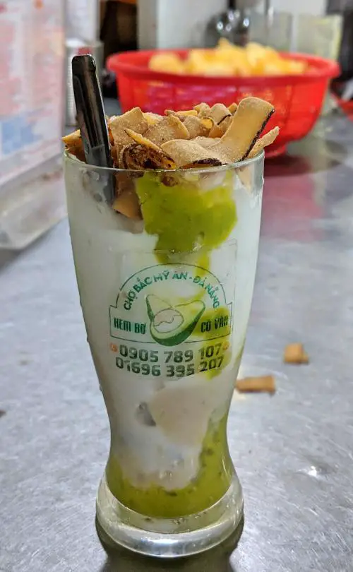In the Bac My An Market in Danang, Vietnam, there is a famous kiosk that sells avocado ice cream with your choice of fruit topping. It's a popular place and also affordable at less than $1 USD.