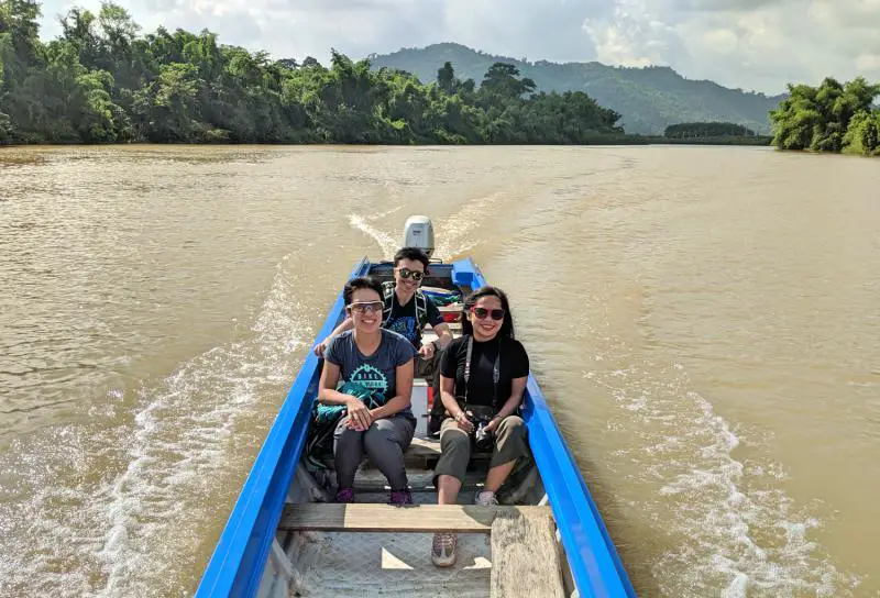 We're riding a boat along the Dong Nai River and Justin is driving it