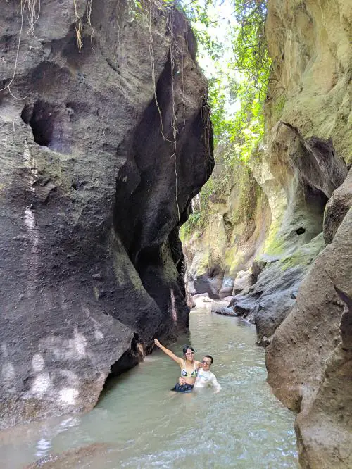 Justin Huynh gives Jackie Szeto, Life Of Doing, a boost while in the waist-deep waters at Hidden Canyon in Bali, Indonesia