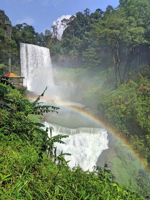 View of the Dambri Waterfall with a rainbow