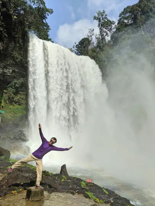 Justin posing next to the Dambri Waterfall.