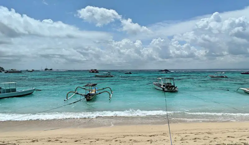 Boats floating in the water along one of the beaches in Nusa Lembongan, Indonesia