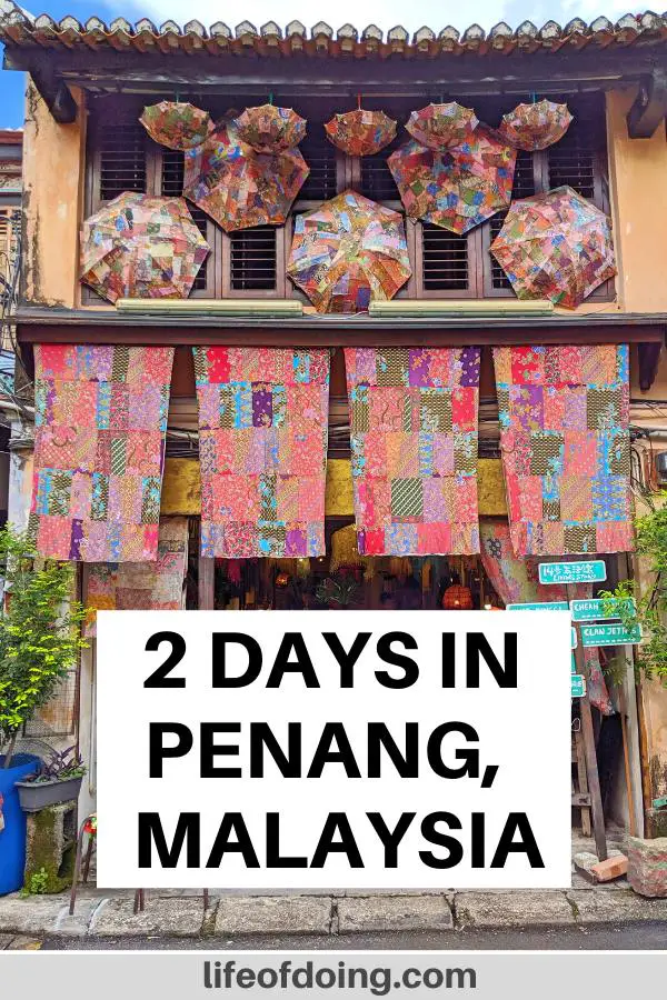 How to spend 2 days in Penang - Check out one of the souvenir shops along Armenian Street in Penang's George Town with colorful fabrics and umbrellas hanging outside of the storefront.