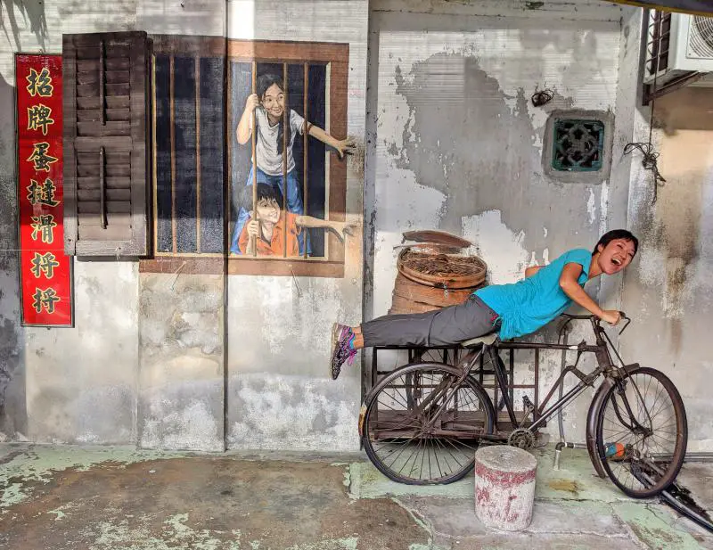 Check out this Penang street art of the children reaching out through their window for the food delivery in the bamboo baskets.