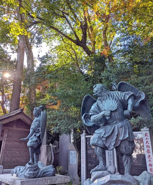 Two tengu, mythical creatures with long noses and wings, guard the entrance of the Yakuoin Temple at the base of Mount Takao.