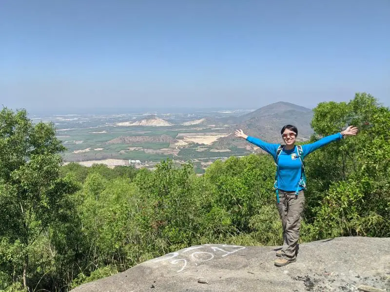 Jackie from Life Of Doing reaches the peak of the Nui Dinh Mountain. It's a great spot as a day trip from Ho Chi Minh City, Vietnam.