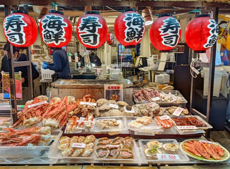 Fresh seafood such as eel, scallops, clams, and crab sold at the Kuromon Market in Osaka, Japan