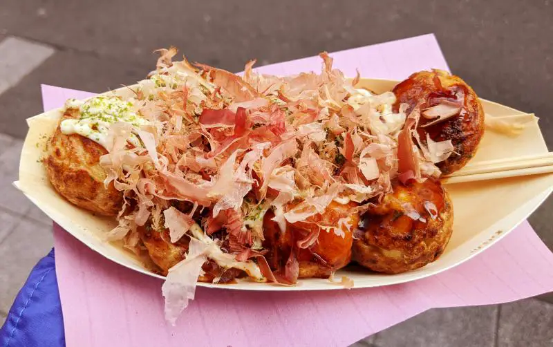 Osaka's Takoyaki Wanaka serves fresh takoyaki which are circular balls with a piece of octopus inside and topped with dried bonito flakes.