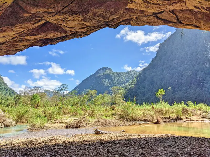 View of the trees and mountains from inside the Hang En Cave entrance in Phong Nha, Vietnam