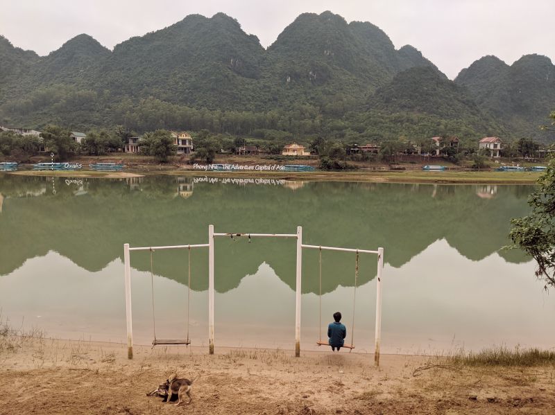 Jackie Szeto, Life Of Doing, sit on the swing with a view of the Son River in Phong Nha, Vietnam