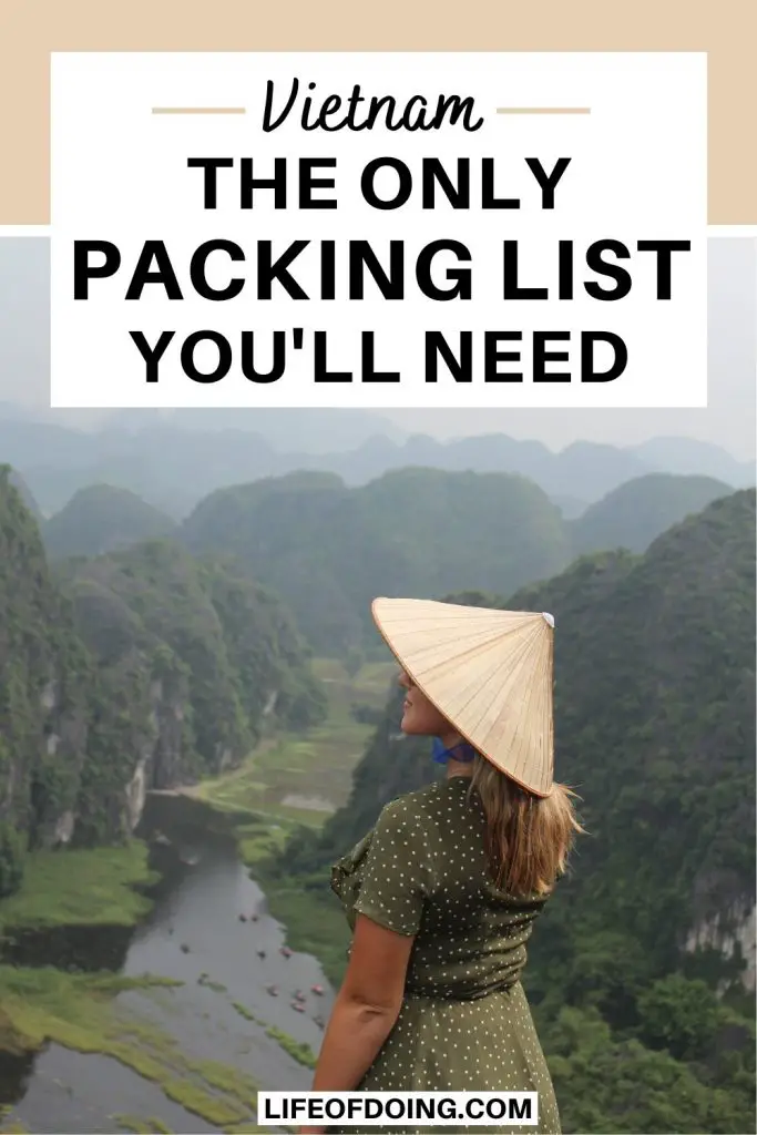 A woman wears a green and white polka dot dress and a conical hat and overlooks Ninh Binh landscapes.