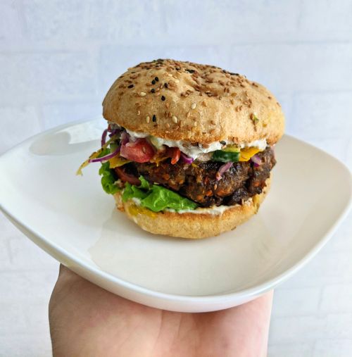 Vegan black bean burger with lettuce, sauce, and a vegan hamburger bun from Zeroism in Ho Chi Minh City, Vietnam