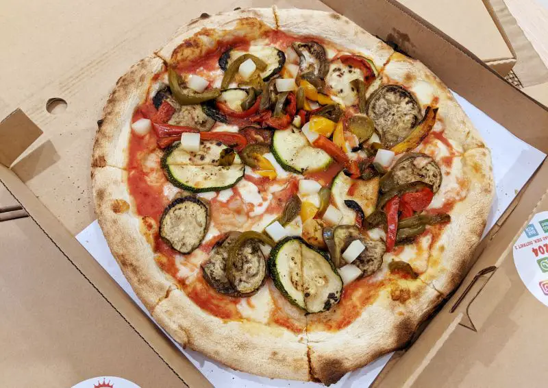 A vegetarian pizza with zucchini, bell peppers, eggplant, and potato cubes from Pizza Reale in Ho Chi Minh City, Vietnam