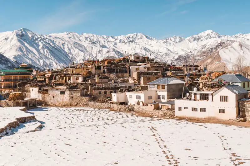 Snowy mountains surrounding a town in Spiti Valley, India