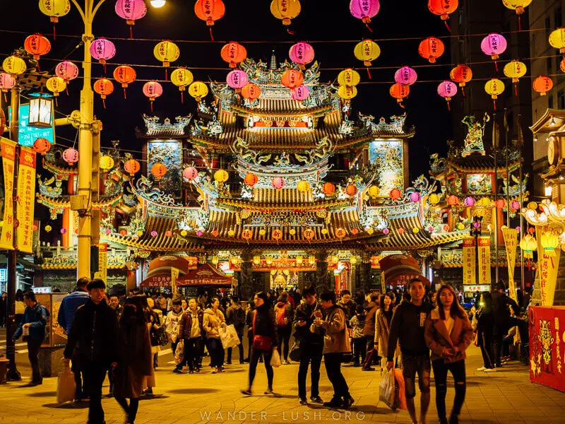 Crowds of people walking and shopping in Taipei, Taiwan with colorful lanterns