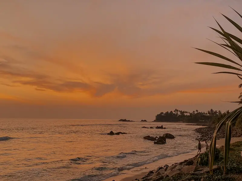 An orange and purple sunset along a beach at Weligama, Sri Lanka