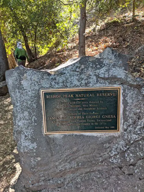 Bishop Peak Natural Reserve sign on a rock along Bishop Peak hiking trail in San Luis Obispo, California