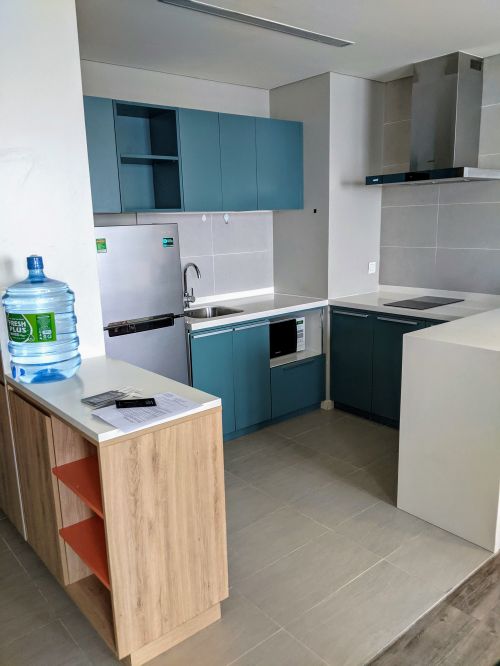 Kitchen area with fridge, sink, microwave, and stovetop at Ibis Saigon Airport