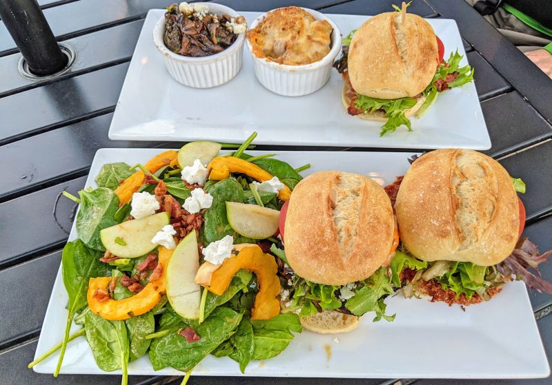Two plates showing 3 sliders, salads, 1 macaroni and cheese, 1 Brussel sprouts, and 1 side salad at Taste Craft Eatery, San Luis Obispo, California