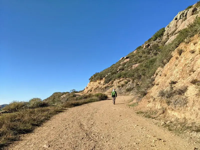 Justin Huynh, Life Of Doing, walks along the gravel Mount Madonna trail in San Luis Obispo, California
