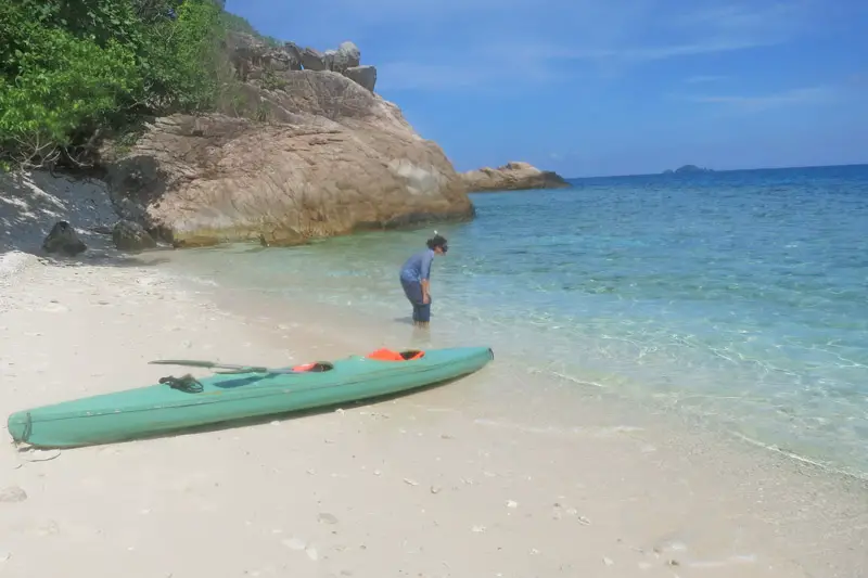 A person standing in the blue waters and ready to go snorkeling at Perhentian Island, Malaysia