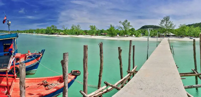 Teal ocean waters surround a walkway for guests to depart the boats and head to the Koh Rong mainland.