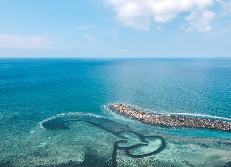 Blue waters surrounded by a rock walkway in Penghu Archipelago in Taiwan