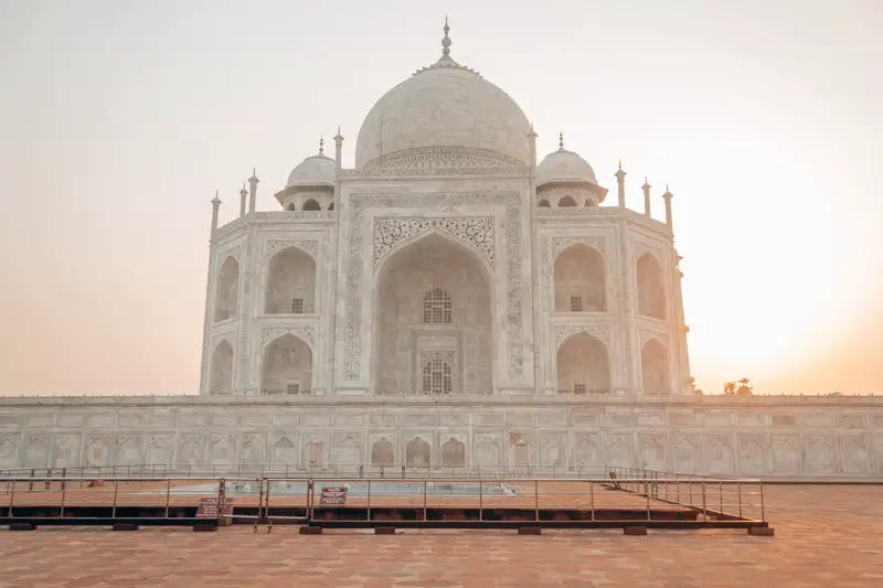 A majestic white temple of Taj Mahal at sunrise