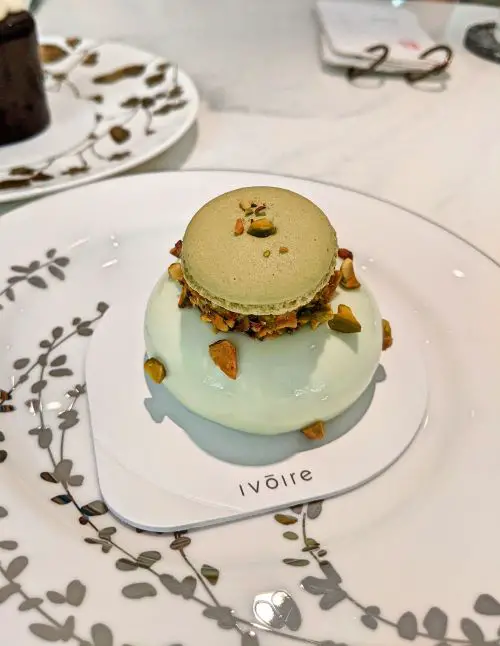 A pistachio dessert with macaron shell and pistachio from Ivoire Pastry