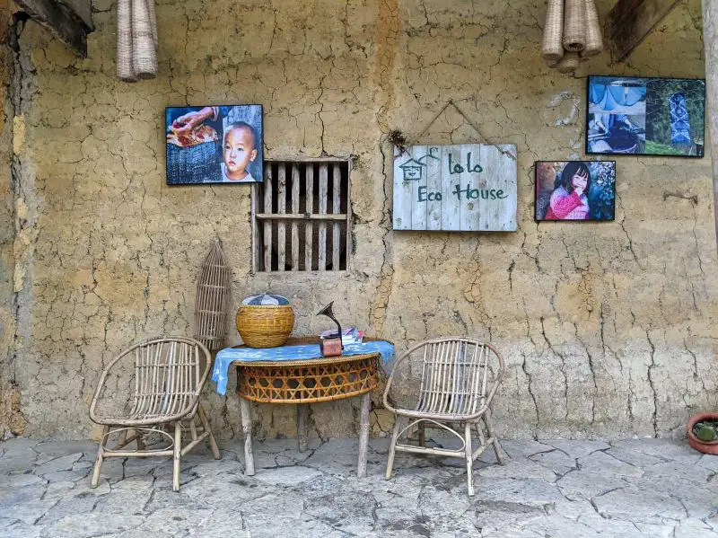 Lo Lo Eco House in Ha Giang, Vietnam has the traditional style house with cracked walls and cute rattan seats.