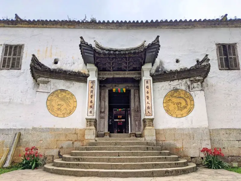 A white and gold palace with Chinese and Vietnamese architecture and paintings of a phoenix and dragon at Vuong Castle, Ha Giang, Vietnam