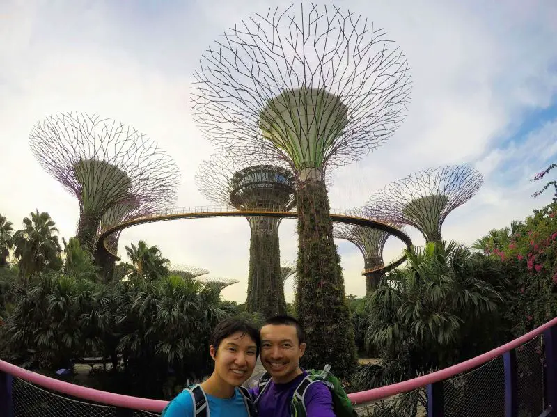 Jackie Szeto and Justin Huynh, Life Of Doing, stand in front of the tall Supertrees and the OCBC Skyway at Gardens by the Bay, Singapore