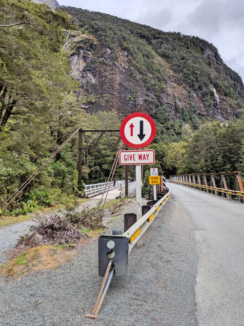 A red, white, and black give way sign along the road in New Zealand