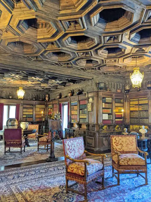 A library with a collection of books and Greek sculptures and pottery at Hearst Castle, San Simeon, California