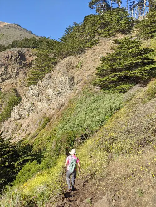 Jackie Szeto, Life Of Doing, walks down a dirt path of Ragged Point Trail, Ragged Point, California