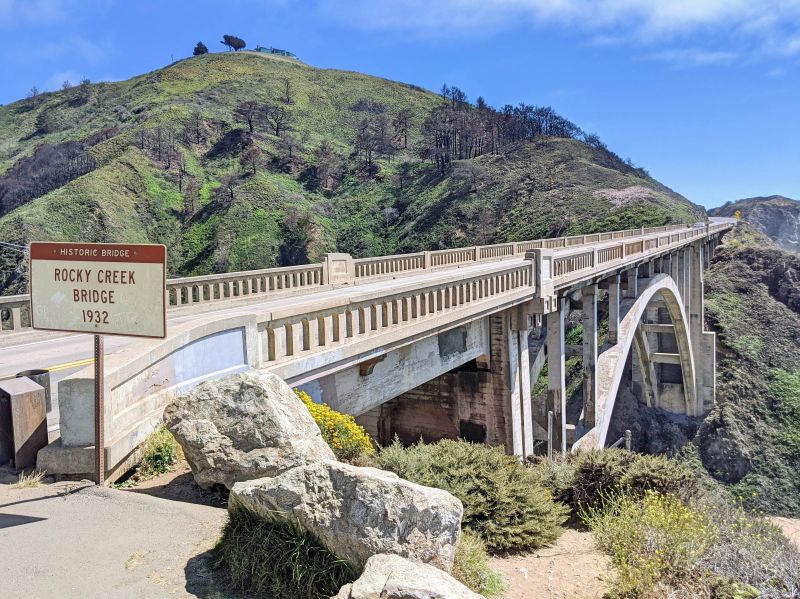 Rocky Creek Bridge sign next to the Rocky Creek Bridge in Big Sur, California