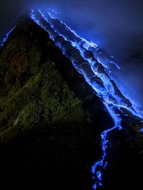 A vibrant dark blue fire along the cracks of the Ijen volcano in Indonesia