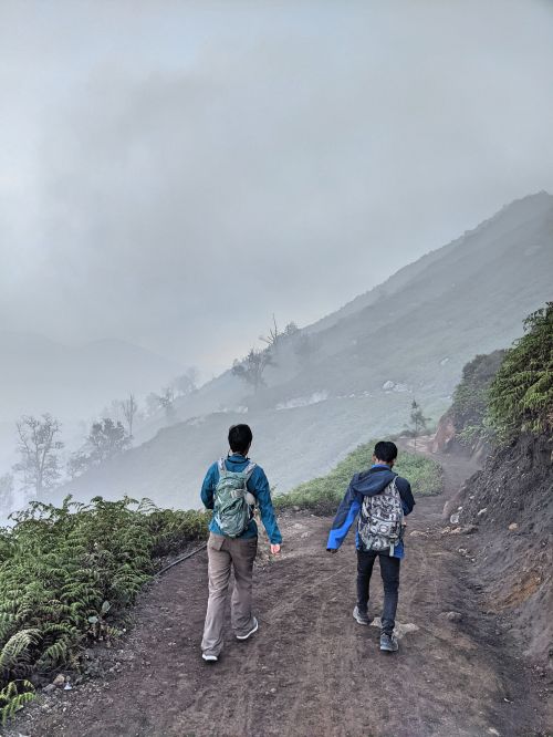 Jackie Szeto, Life Of Doing, and guide walk on the dirt path on Ijen volcano