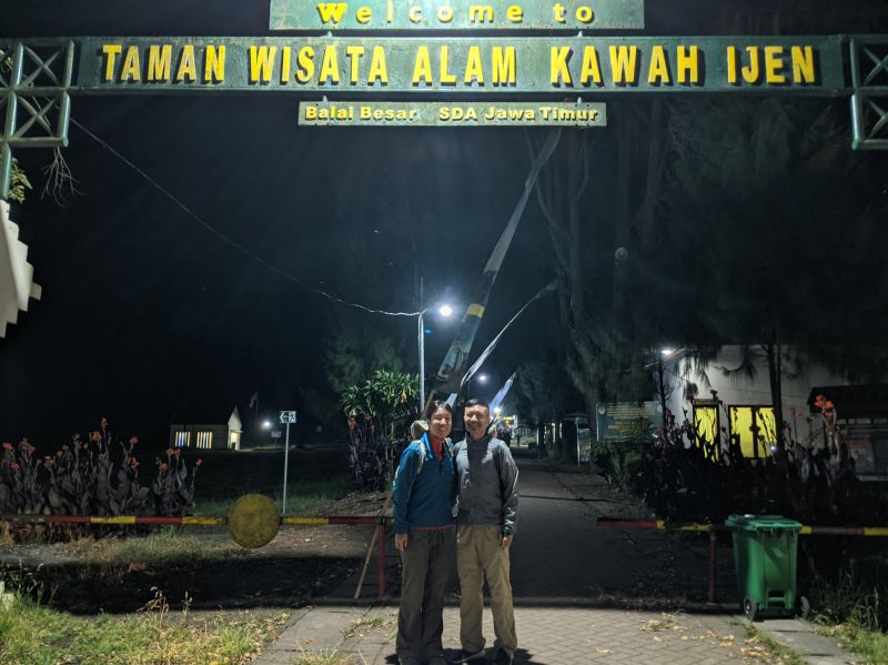 Jackie Szeto and Justin Huynh, Life Of Doing, stand under the Kawah Ijen sign at night
