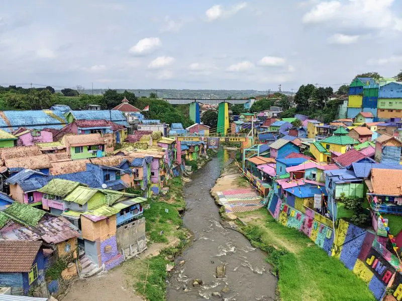 Indonesia's Malang has villages with colorful houses and roofs and a river flowing between them