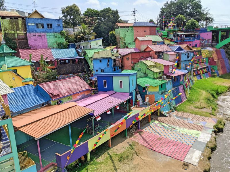Pink, blue, purple, and yellow houses and roofs at Kampung Warna Warni Jodipan in Malang, Indonesia