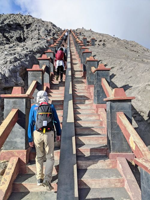 Justin Huynh, Life Of Doing, climbs up the wooden staircase to reach the peak of Mount Bromo crater