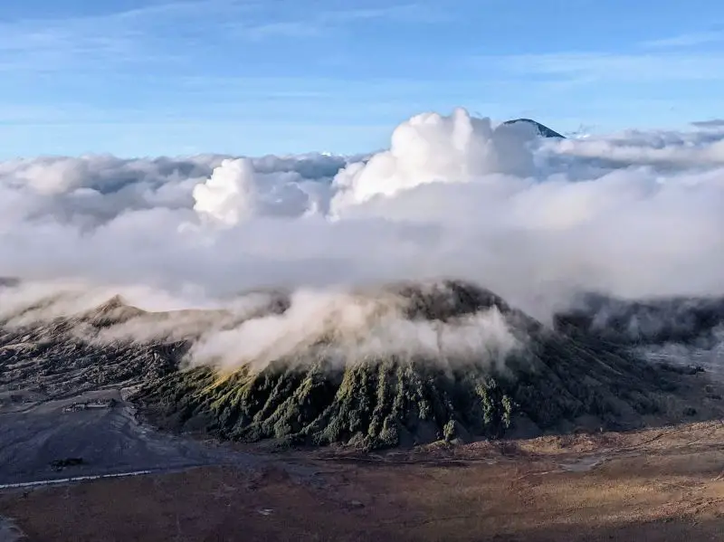 Layers of clouds on top of Bromo crater after sunrise